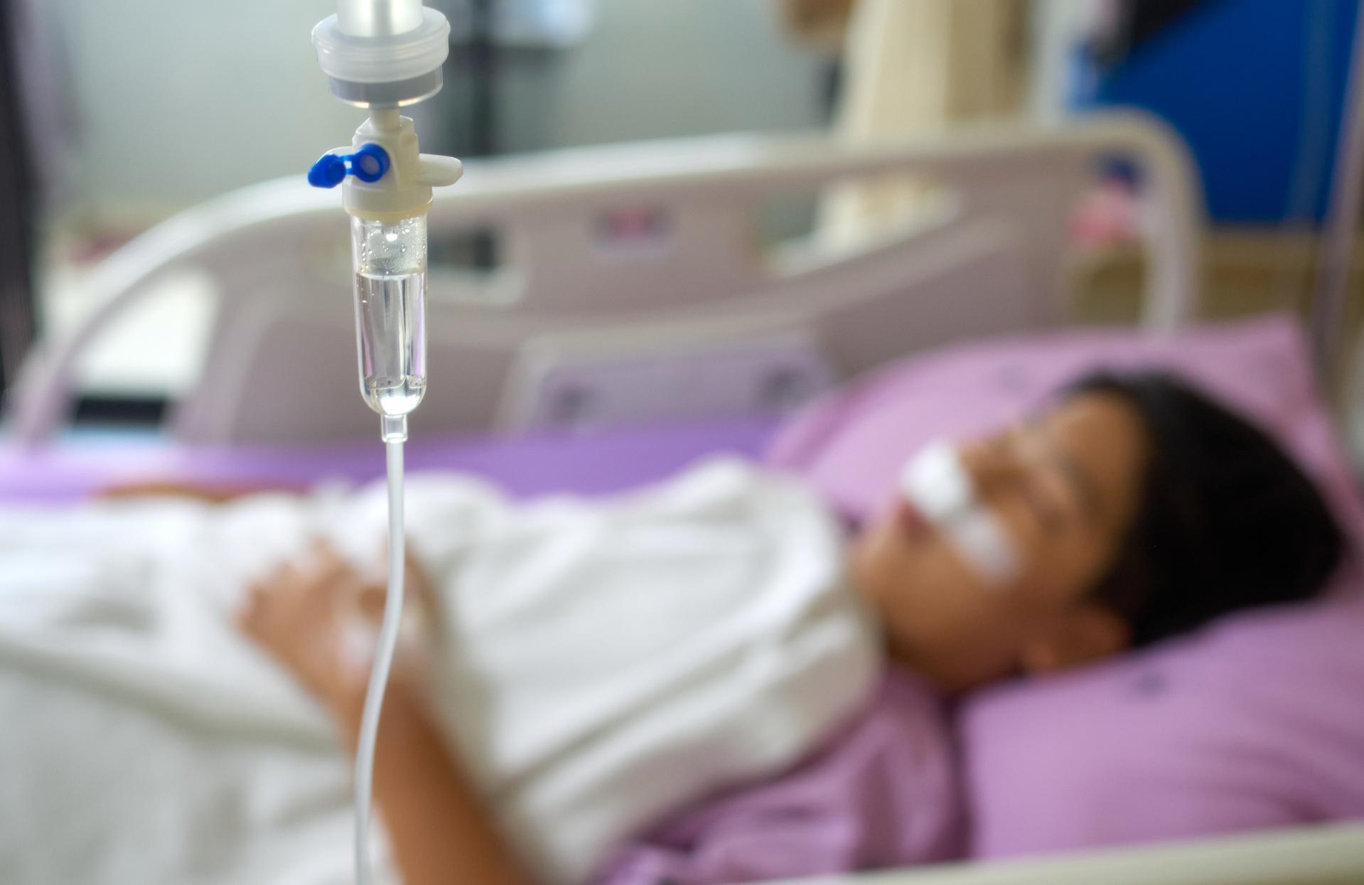 Close-up view of the saline bag and a patient